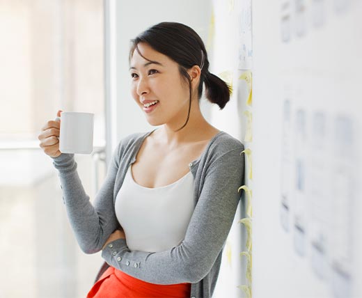 young asian woman with a cup of coffee